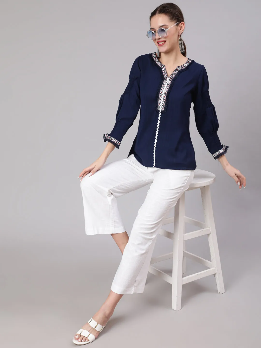 A Blue Silk Blend Lace Embellished Top With Smocked Sleeves With Wide-Leg White Pants